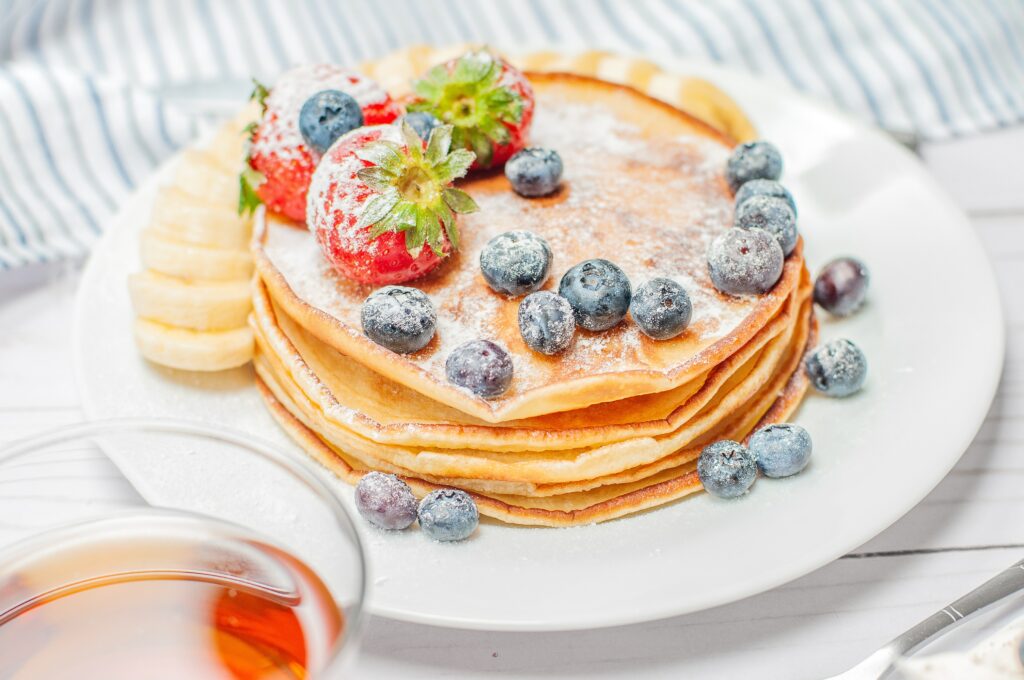 Stack of blueberry pancakes with powdered sugar